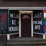 artist mural on storefront. ext in mural says "We can be heroes just for one day."