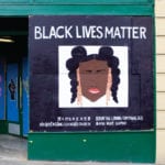 Black Lives Matter mural on boarded up store front