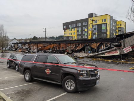 Fire Department vehicle parked in front of fire-destroyed strip-mall