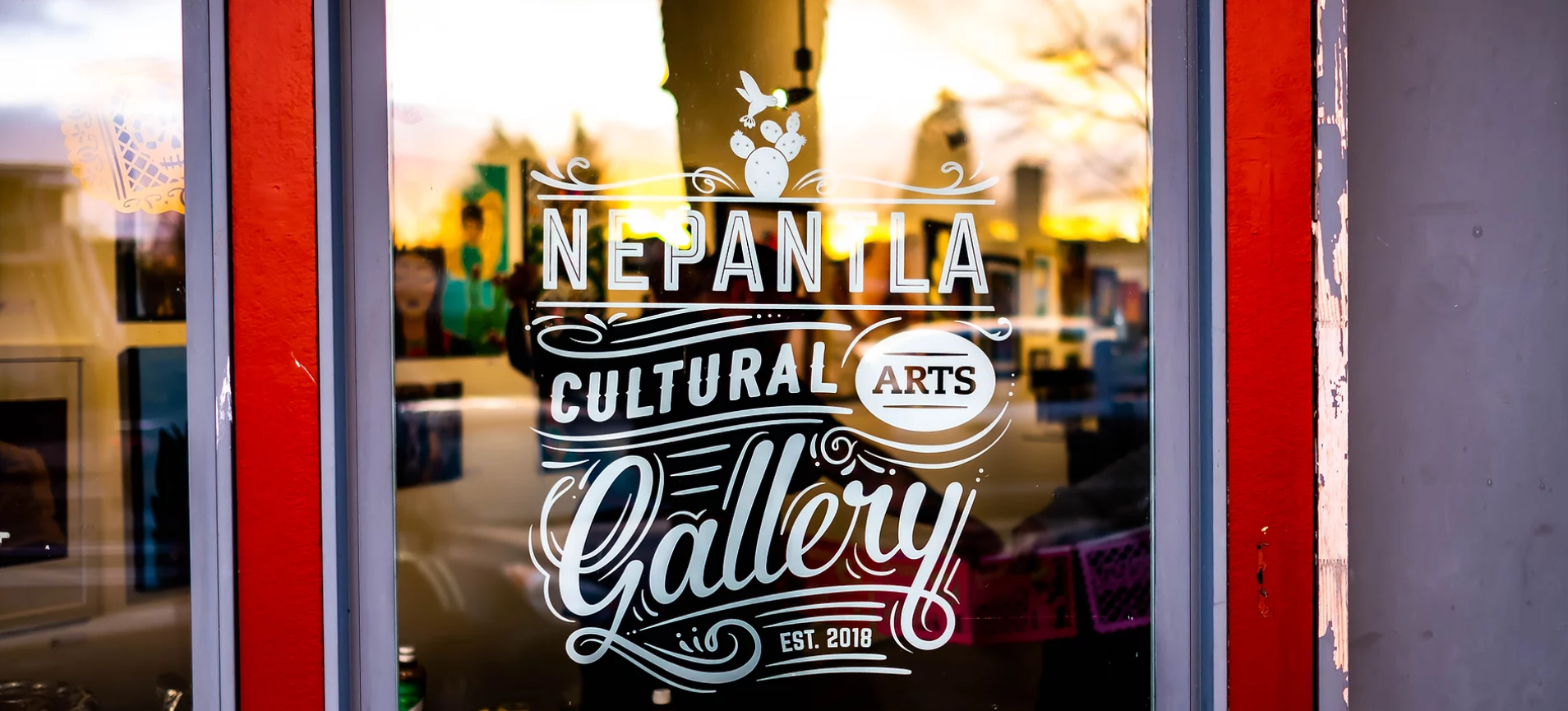 glass front door of Nepantla Cultural Arts Gallery