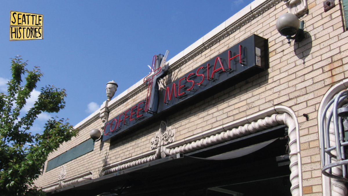 exterior of light colored brick building with neon sign that reads 