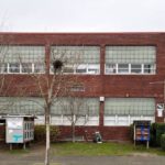 photograph of Alki Elementary school, a two-story brick building with large windows