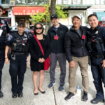 Members of Seattle Chinatown Block Watch stand with Seattle police officers in the neighborhood