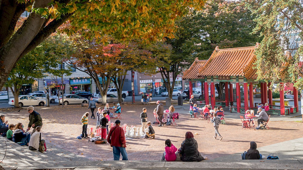 People gathered in Hing Hay park in the Chinatown International District engaged in many different activities