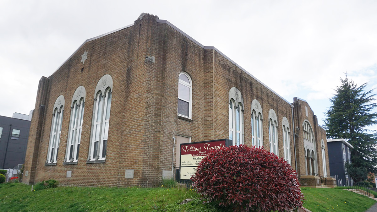 exterior of Tolliver Temple, a brick building with tall arched windows.