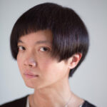 headshot of androgynous looking Chinese man with asymmetrical haircut