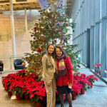 Jenifer Chao poses with her mom in front of a Christmas tree in the lobby of City Hall.