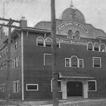 A ventage, black and white photo of a brick building with