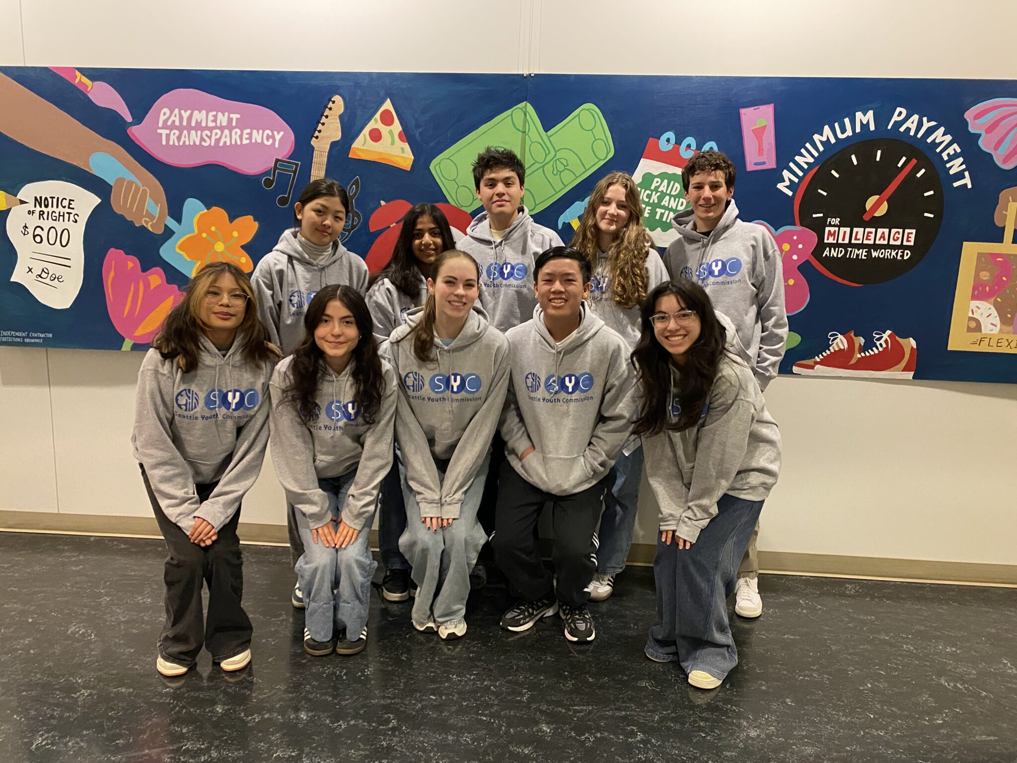 Seattle Youth Commission group picture of ten youth wearing matching sweatshirts and smiling.