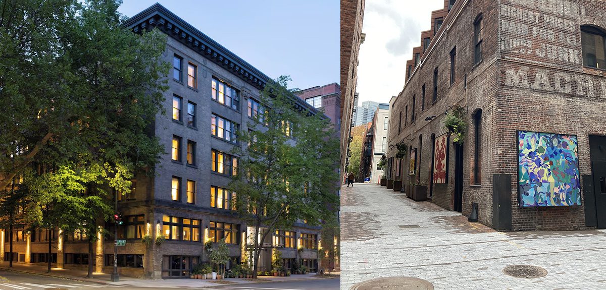 exterior photo of brick facade with windows glowing with light. View down an alley in Pioneer square paved with bricks, walls hung with art and rail road ties exposed in the paving.