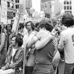 Black and white photo of a crowd of people in a city square at Seattle's fist Gay Pride gathering