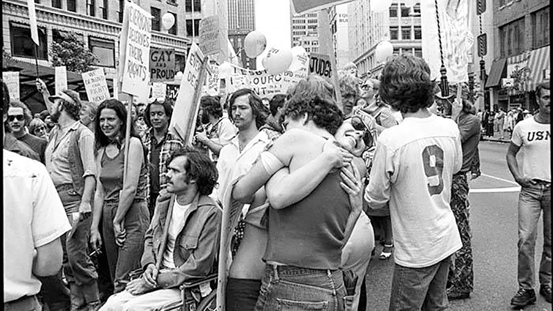 Black and white photo of a crowd of people in a city square at Seattle's fist Gay Pride gathering