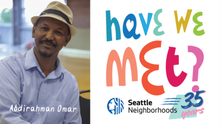 Headshot of a Black man wearing a blue button-up shirt and straw fedora and text on the bottom that says, "Abdirahman Omar." Text graphic on the right of the photo reads, "Have We Met?" with the Seattle Department of Neighborhoods logo beneath